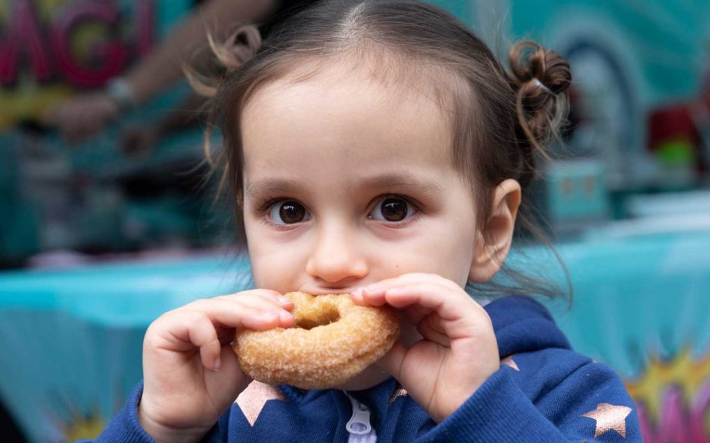 Little Girl Enjoying OMG! Decadent Donuts
